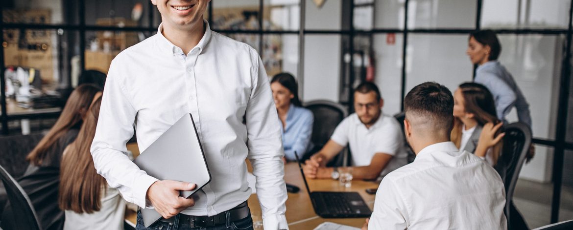 16056 a guy smiling with holding laptop